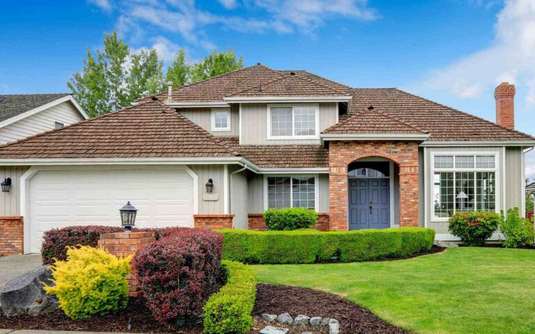 home with white siding and brick exterior accent