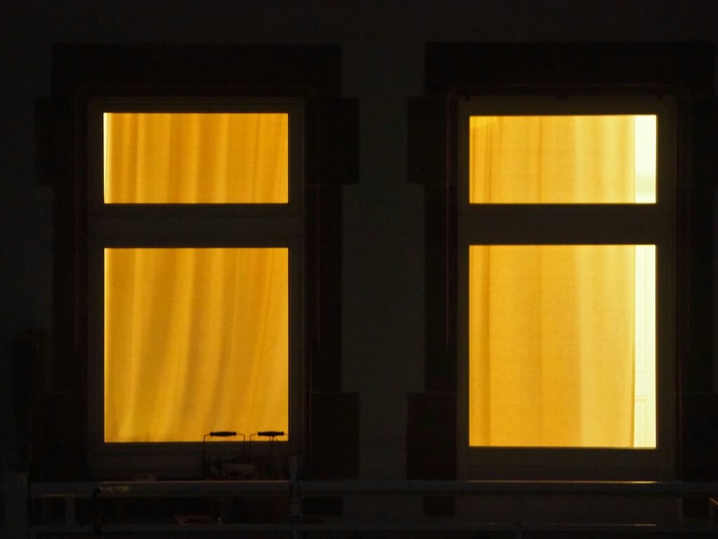 brightly lit windows from outside a home at night